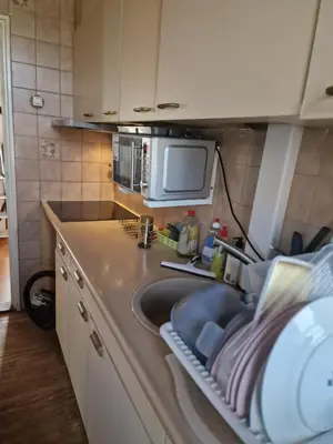 a kitchen with a sink and a microwave at Short stay in Weesp