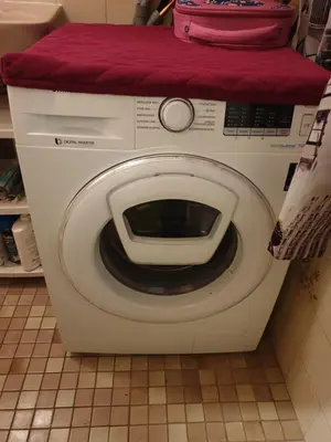 a washing machine with a pink bag on top of it at Short stay in Weesp