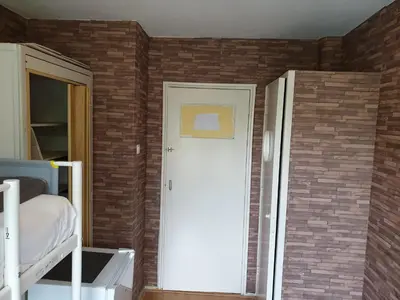 a room with a door and a brick wall at Short stay in Weesp