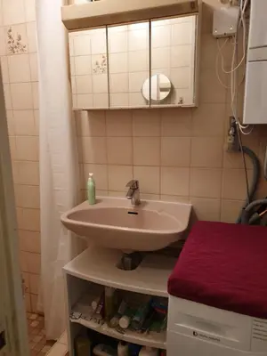 a bathroom with a sink and a red stool at Short stay in Weesp