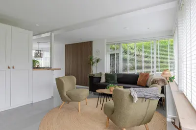a living room with a couch and chairs and a table at Rekerlanden 58 - De Boet in Warmenhuizen