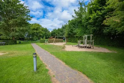 a path in a park with a playground at Rekerlanden 58 - De Boet in Warmenhuizen
