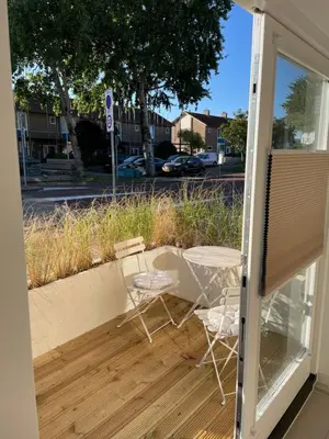 a patio with two chairs and a table at Knusse kamer met zonnig terrasje in Zandvoort