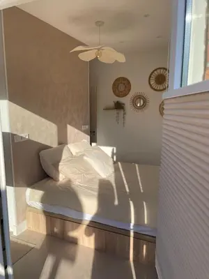 a bedroom with a bed and a ceiling fan at Knusse kamer met zonnig terrasje in Zandvoort