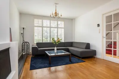 a living room with a couch and a table at Lovely House in Zeist