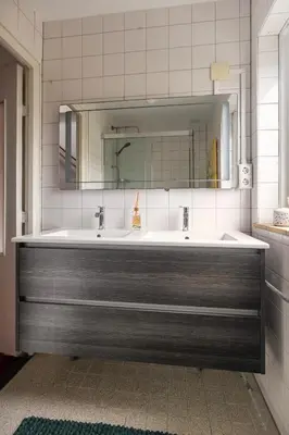 a bathroom with a large sink and a mirror at Lovely House in Zeist