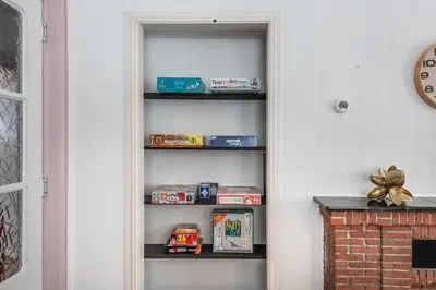 a book shelf with toys on it next to a wall at Private Estate Villa near Amsterdam with Hottub 12p in Abcoude