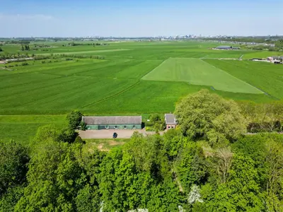 an aerial view of a house in the middle of a field at Private Estate Villa near Amsterdam with Hottub 12p in Abcoude