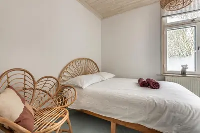 a bedroom with two chairs and a bed and a window at Private Estate Villa near Amsterdam with Hottub 12p in Abcoude