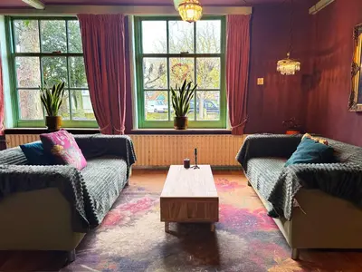 a living room with two couches and a coffee table at De Noorderzon in Benningbroek