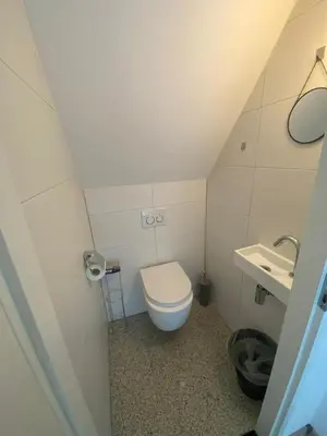 a small bathroom with a toilet and a sink at Villa-43 in Sint Maarten