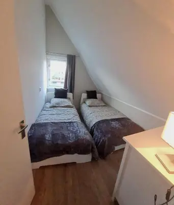 two beds in a small room with a window at Villa-43 in Sint Maarten