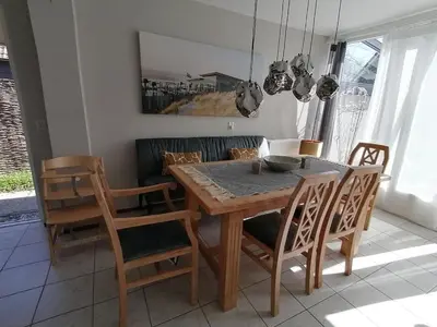 a dining room with a wooden table and chairs at Villa-43 in Sint Maarten