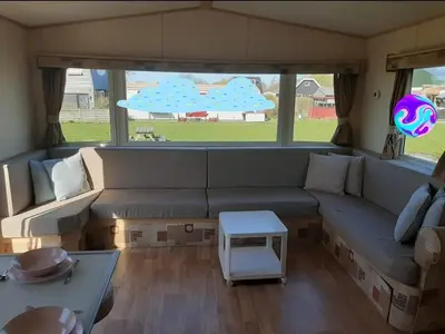 a living room with a couch and a table at Arizonahaus Holland Nähe Meer in Dirkshorn