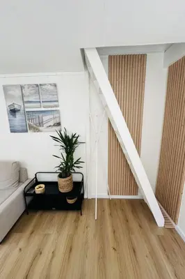 a living room with a couch and a table at Holiday Home Tiny House QuDi by Interhome in Noordwijk
