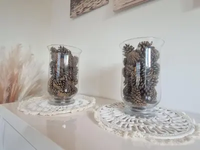 two glass vases sitting on top of a table at Holiday Home De Bosuil by Interhome in Noordwijk aan Zee