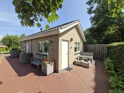 a tiny house on a brick patio at Holiday Home De Bosuil by Interhome in Noordwijk aan Zee