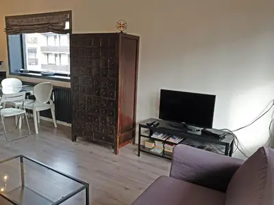 a living room with a couch and a tv and a table at Apartment Bella by Interhome in Noordwijk aan Zee