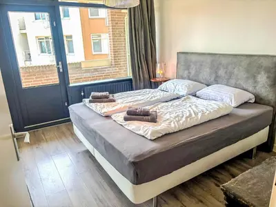 a bed with two pillows on it in a bedroom at Apartment Bella by Interhome in Noordwijk aan Zee