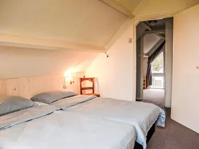 a bedroom with a large bed in a room at Holiday Home Sunset by Interhome in Noordwijkerhout