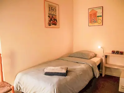a bedroom with a bed with a towel on it at Holiday Home Sunset by Interhome in Noordwijkerhout