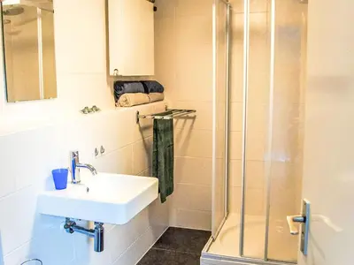 a bathroom with a sink and a shower at Holiday Home Sunset by Interhome in Noordwijkerhout