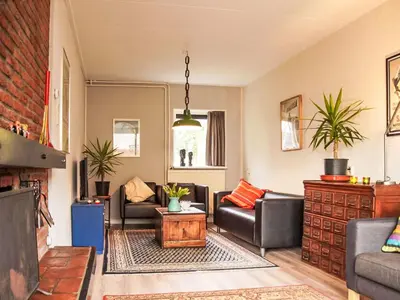 a living room with couches and a table at Holiday Home Sunset by Interhome in Noordwijkerhout