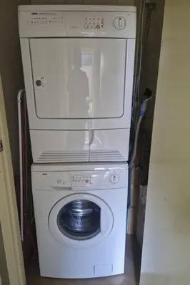 a washing machine with a microwave on top of it at Holiday Home Zeelust by Interhome in Noordwijkerhout