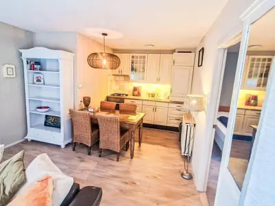 a kitchen and dining room with a table and chairs at Holiday Home Zeemeeuw by Interhome in Noordwijkerhout
