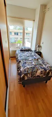 a bedroom with a bed and a large window at Villa near Amsterdam in Almere