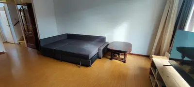 a living room with a black bed and a stool at Villa near Amsterdam in Almere
