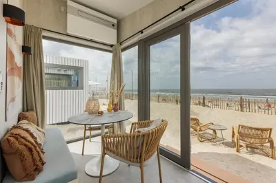 a living room with a view of the beach at Cabana's direct op het strand in Zandvoort