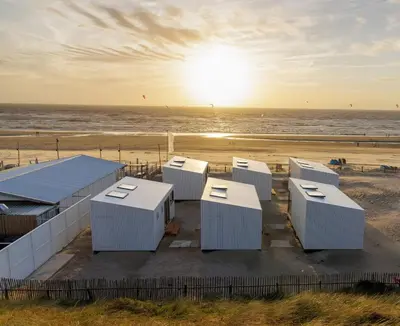 a group of huts on the beach at sunset at Cabana's direct op het strand in Zandvoort