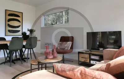 a living room with a couch and a table and a tv at Cozy Home In Vinkeveen With Harbor View in Vinkeveen