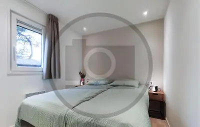 a bedroom with a bed and a round mirror at Cozy Home In Vinkeveen With Harbor View in Vinkeveen