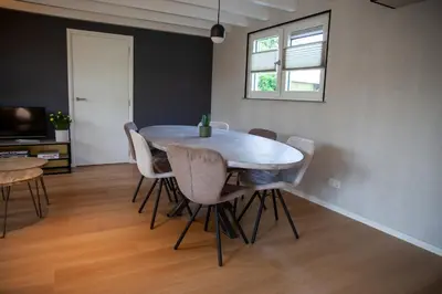 a dining room with a table and chairs at De Tuinfluiter 7 in Noordwijk aan Zee