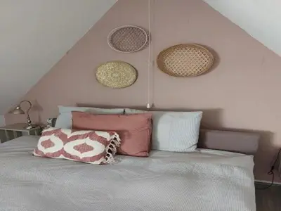 a bedroom with a bed with baskets on the wall at Dirkshorn Holiday Home for 4 in Dirkshorn