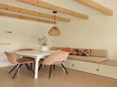 a dining room with a white table and chairs at Dirkshorn Holiday Home for 4 in Dirkshorn