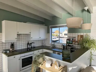a kitchen with white cabinets and a large window at Chalet Kievietsbuurt Roeleveld Estate in Breukelen