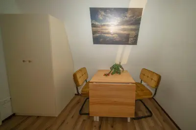 a table and chairs in a room with a picture on the wall at Studio De Gravin in Gouda