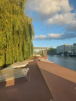 a row of boats parked on the side of a river at Cornelia Below Deck in Amsterdam