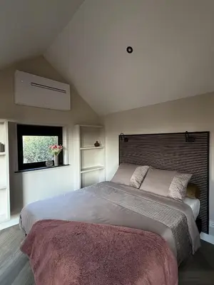 a bedroom with a large bed and a window at B&B Landslake II in Landsmeer