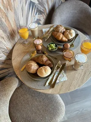 a table with plates of pastries and glasses of orange juice at B&B Landslake II in Landsmeer