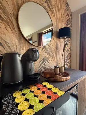 a counter top with cupcakes and a mirror at B&B Landslake II in Landsmeer