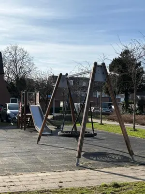 a row of playground equipment in a parking lot at Vakantiehuis Neptunus voor het hele gezin eventueel met baby in Katwijk aan Zee
