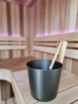 a black cup sitting on a table with two chopsticks at LÖYLY Egmond in Egmond aan Zee