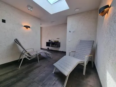 a room with two chairs and a table and a skylight at LÖYLY Egmond in Egmond aan Zee