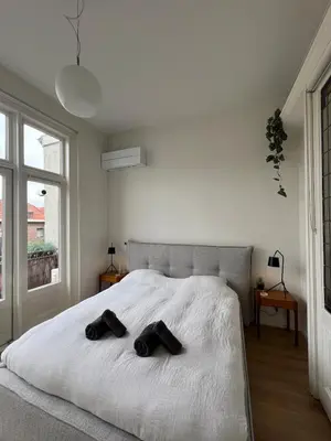 a bedroom with a bed with two black shoes on it at Modern & Luxurious stay Haarlem in Haarlem