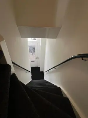 a flight of stairs in a building with a window at Modern & Luxurious stay Haarlem in Haarlem