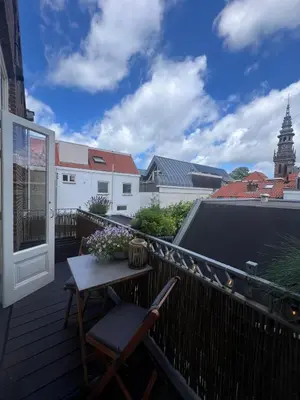 a balcony with a table and chairs on a building at Modern & Luxurious stay Haarlem in Haarlem